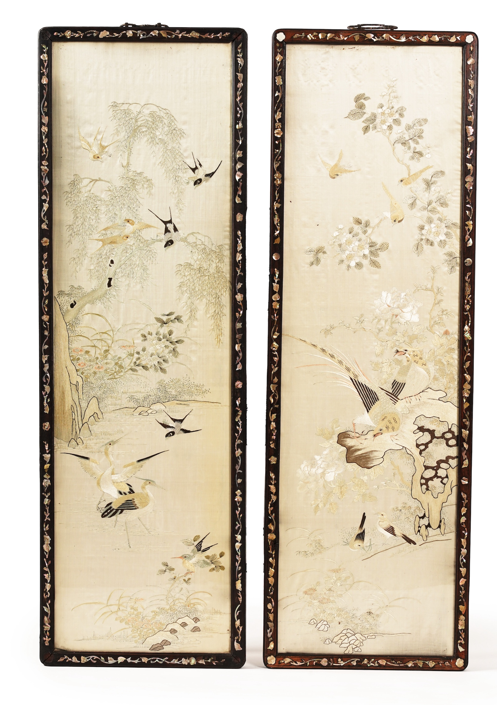 A pair of Chinese embroidered silk ‘bird’ panels, in mother-of-pearl inlaid hongmu frames, late 19th/early 20th century